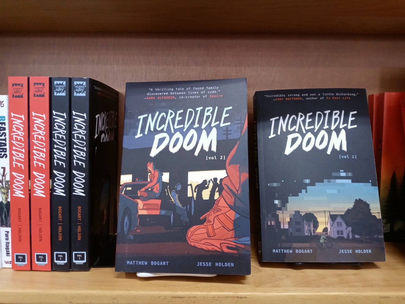 Copies of Incredible Doom Vol. 1 and 2 sitting on a bookstore shelf. 